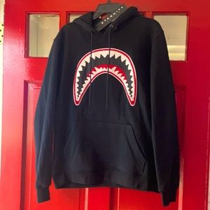 Black hoodie it’s a large logo is a black red and white  patch. Nice!!!